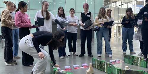 Girls watching robots in an obstacle course